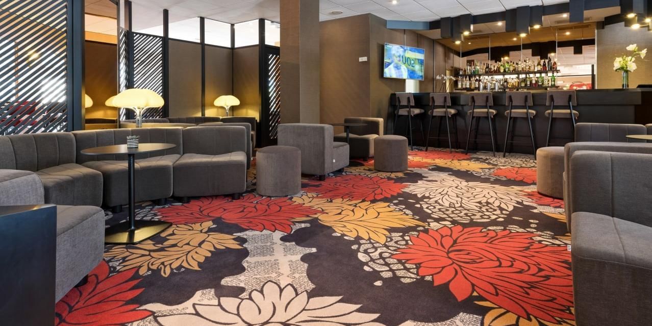 Intérieur du bar avec moquette florale aux Oceania Hotels