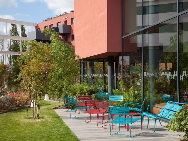 Colorful lounge area arranged outdoors at Nomad Hotel Paris Roissy